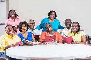 African American men and women at bible study meeting